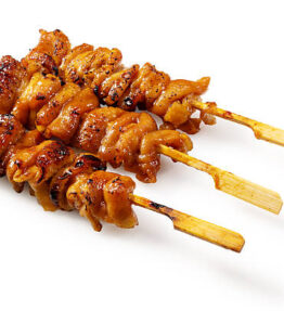 Three Japanese Yakitori Chicken Skin Skewers with Soft Shadow Isolated on White Background, Oblique View